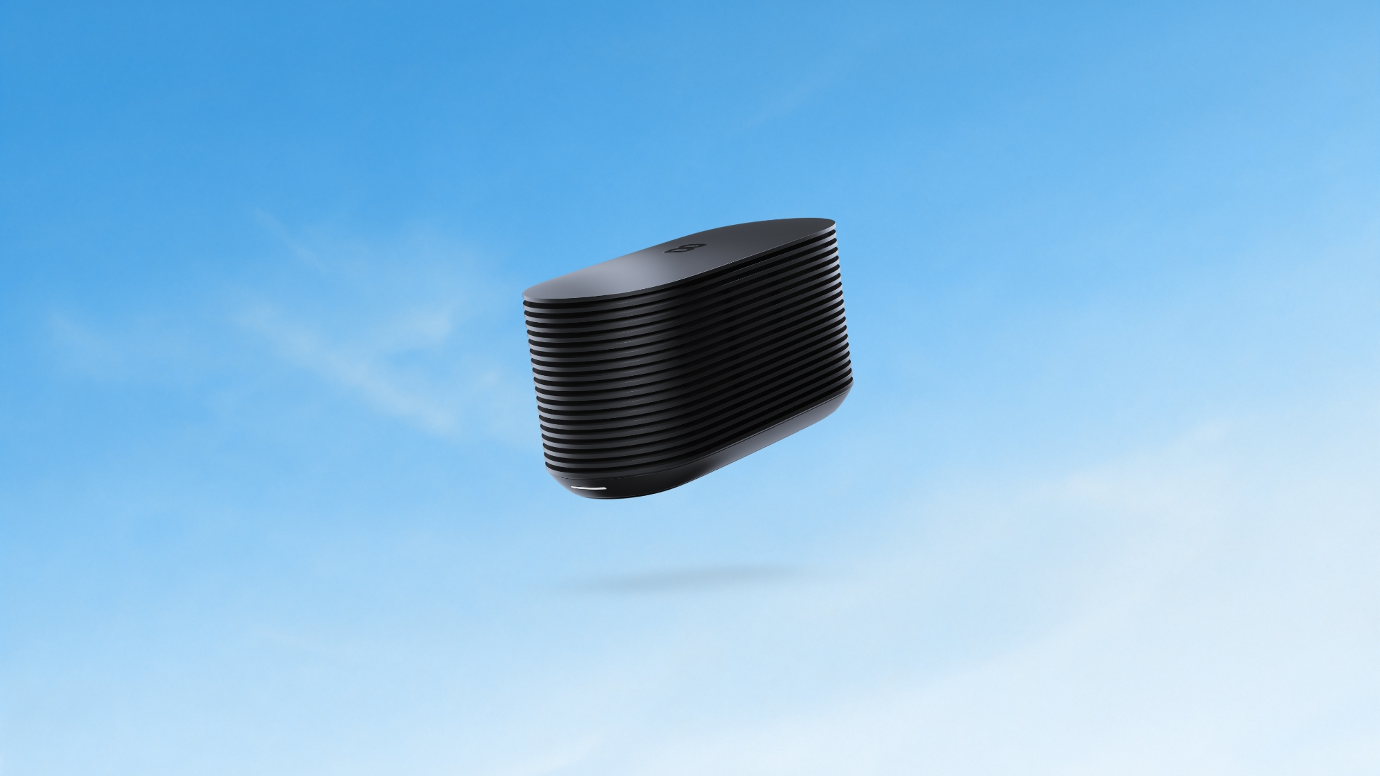 Black ribbed rectangular sleep device with a smooth gray top against a blue gradient background.