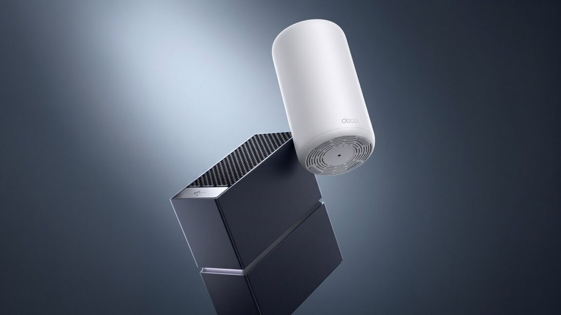 A white cylindrical Deco device floats above a dark angular router against a gray background.