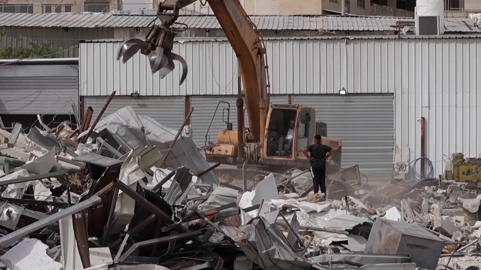 Israel bulldozes Palestinian shops to make way for settlement-linked road