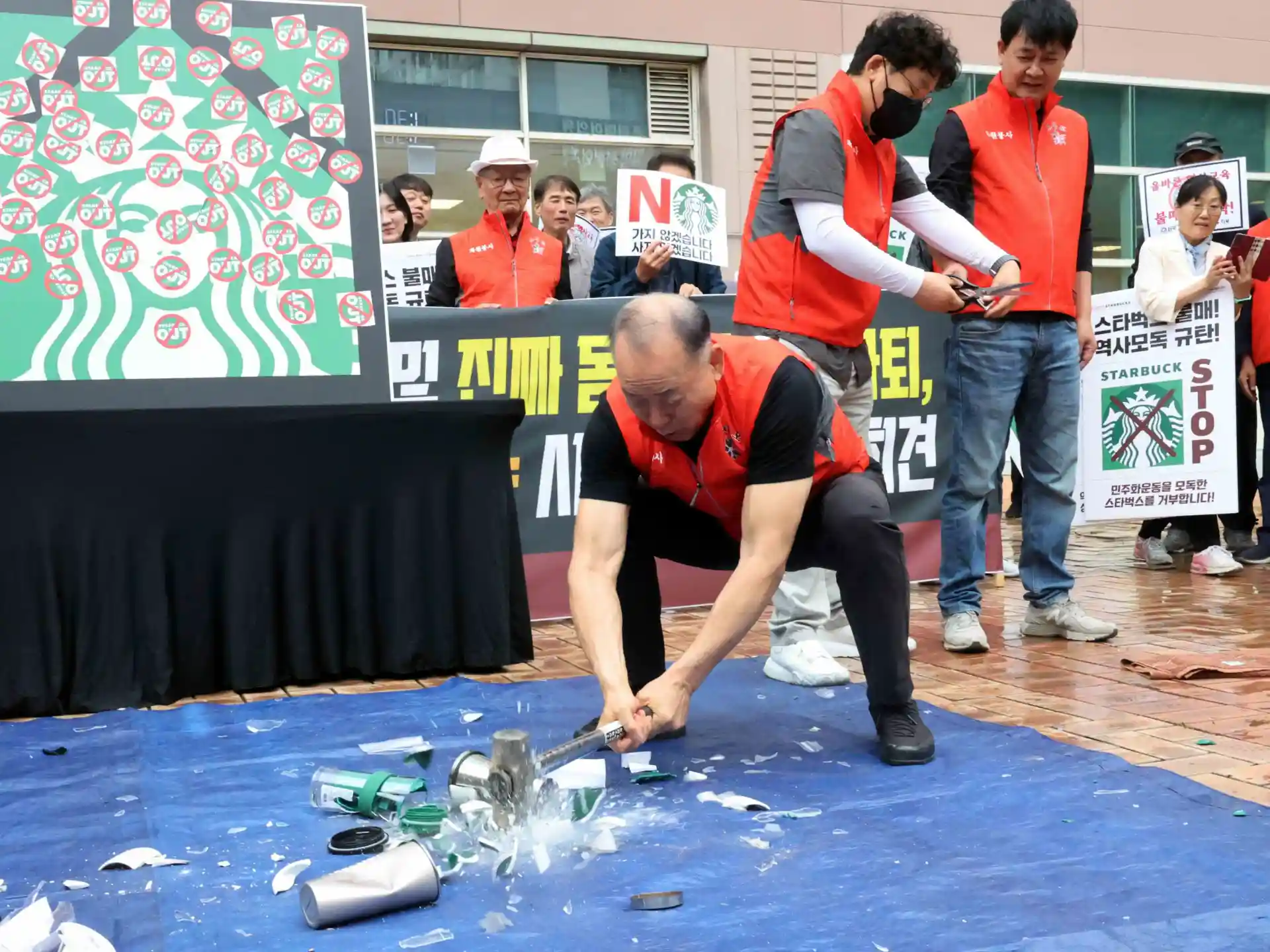 South Korean activists smash Starbucks cups to protest ‘Tank Day’ campaign
