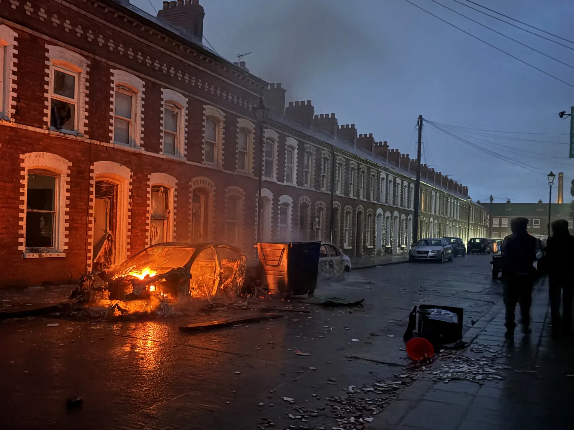 Protesters torch cars, buildings in Belfast after knife attack