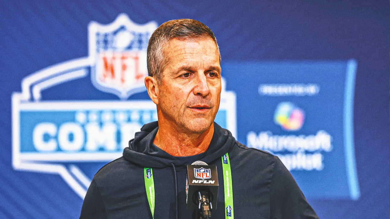 Football coach speaking into an NFL microphone at a media event