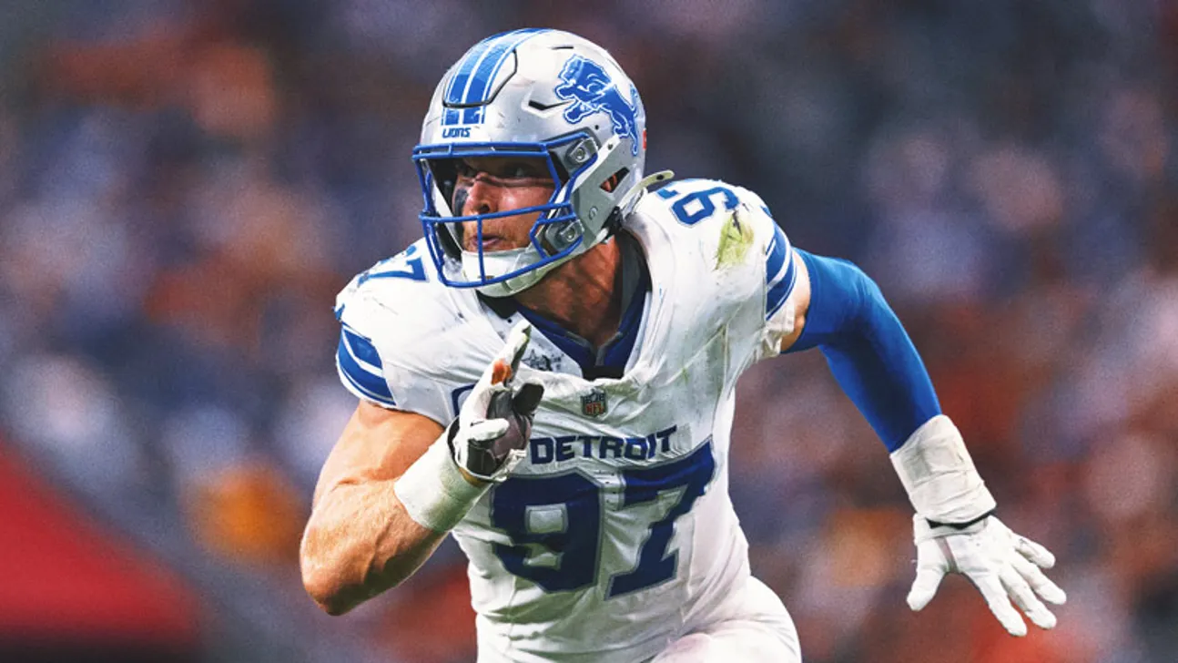 Detroit Lions football player in uniform running with the ball during a game