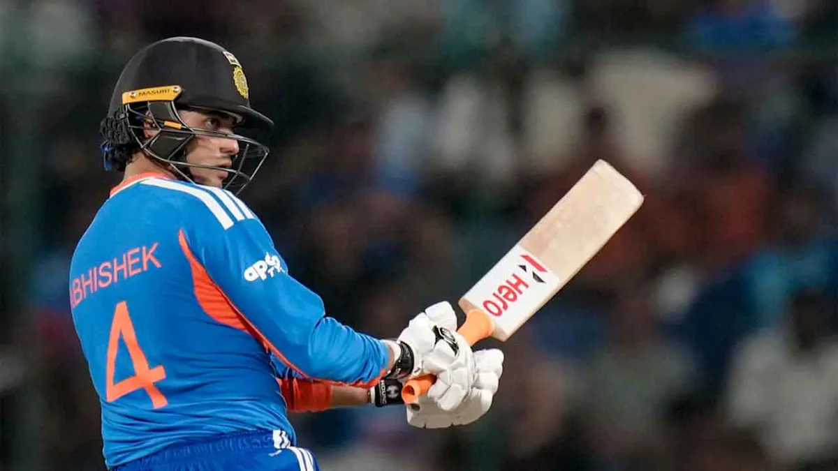 Cricketer in blue India jersey and helmet holding a bat after playing a shot