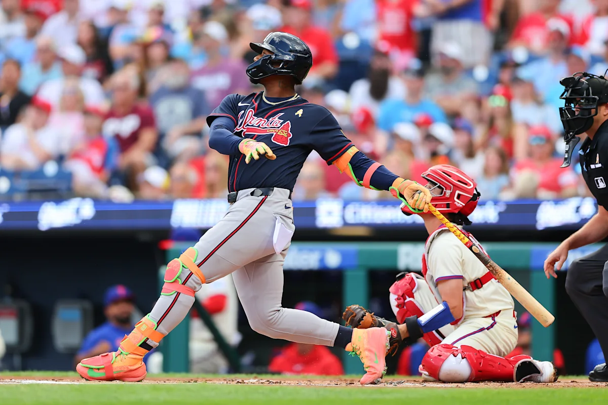 Atlanta batter swings as catcher and umpire watch during a baseball game.