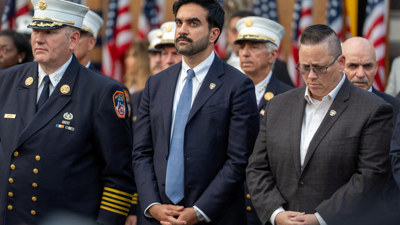 Officials and uniformed military personnel stand together during a formal ceremony.