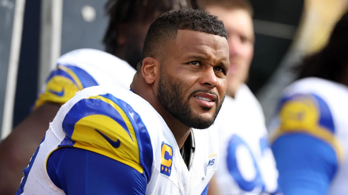 Football player in a blue-and-yellow uniform looks toward the sideline during a game.