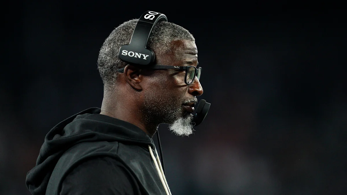 Man wearing Sony headset and glasses, shown in profile against a dark background