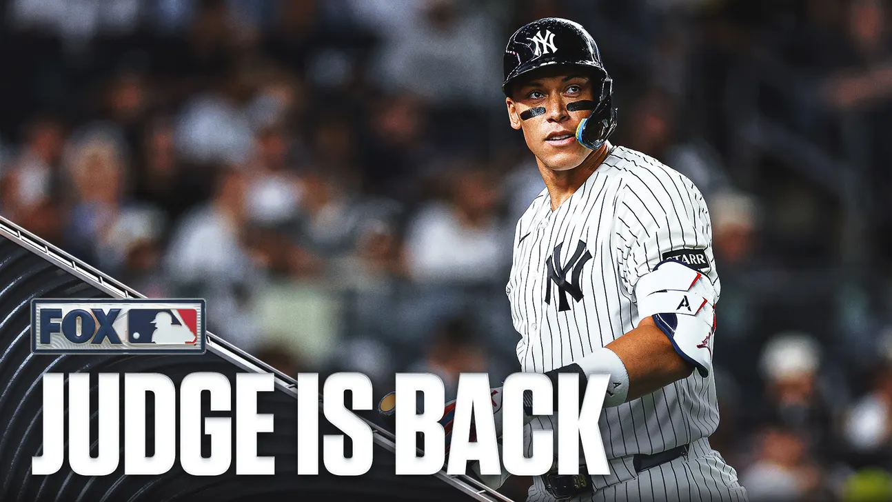 New York Yankees player in pinstripes wearing a batting helmet during a game