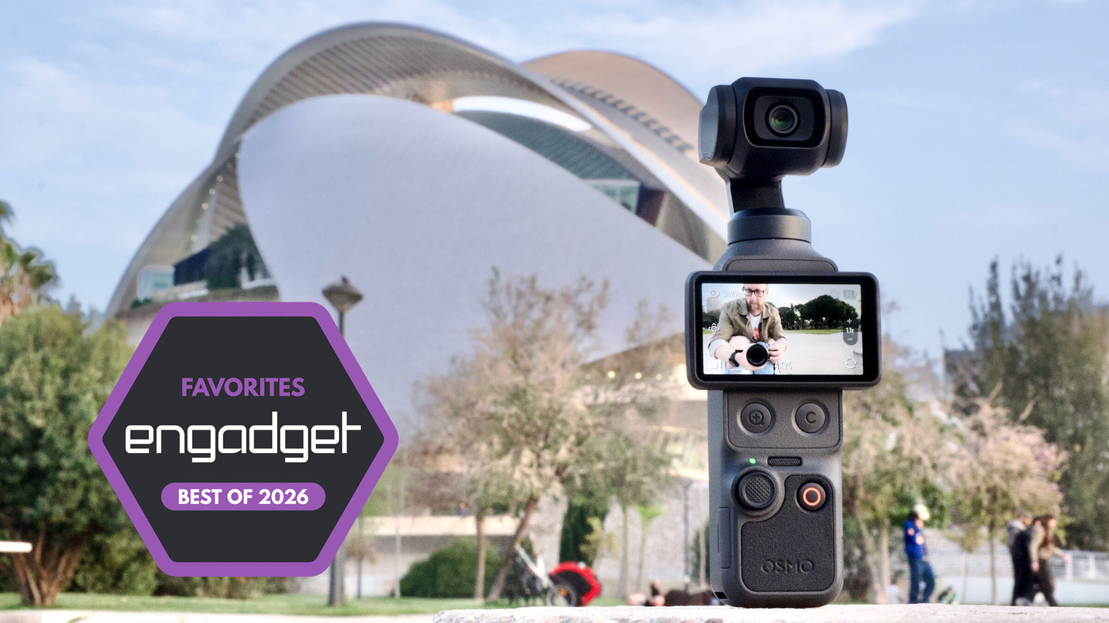 A handheld DJI Osmo camera stands before a modern building, with an Engadget Best of 2026 badge beside it.