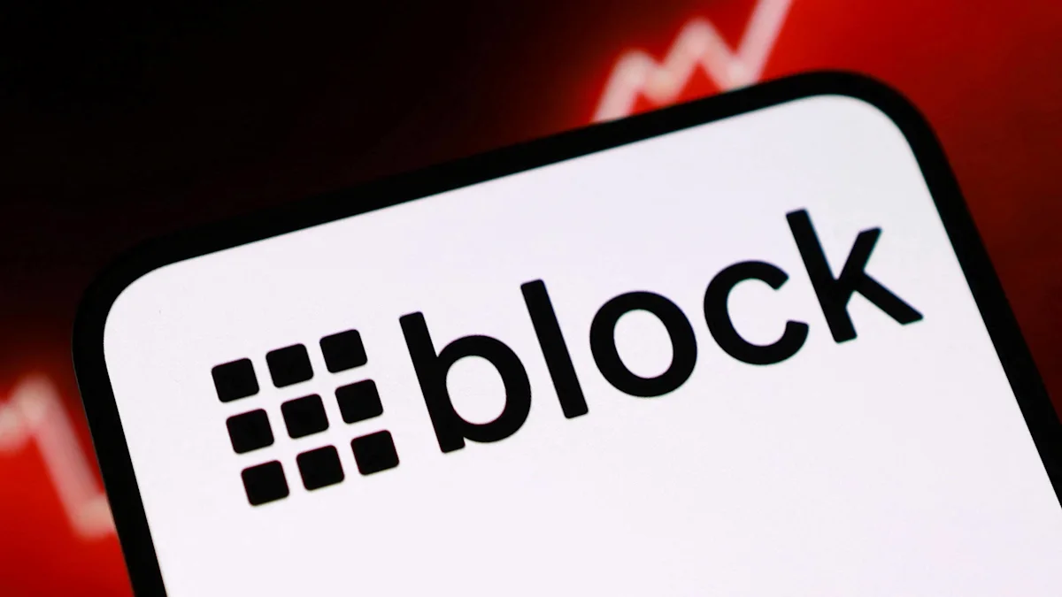 Close-up of a smartphone displaying the black Block logo against a blurred red background.