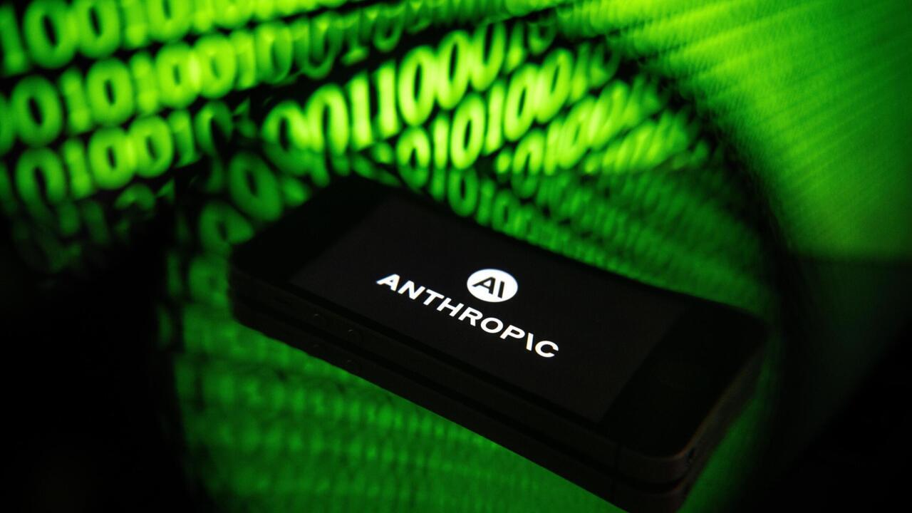 Anthropic logo displayed on a black device surrounded by glowing green binary digits