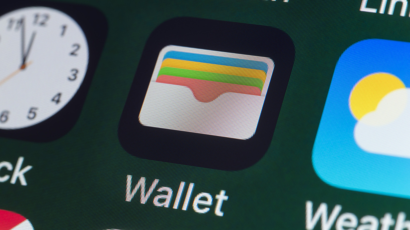 Close-up of a smartphone screen showing a Wallet app icon among other application icons