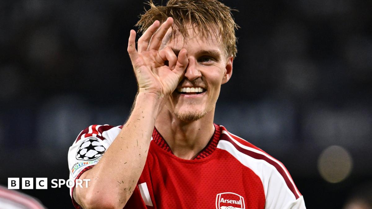 Arsenal footballer smiling and making an OK gesture during a match