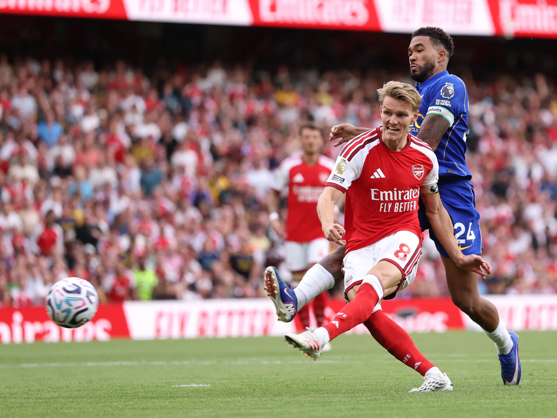 Arsenal and Chelsea players contest the ball during a Premier League football match.