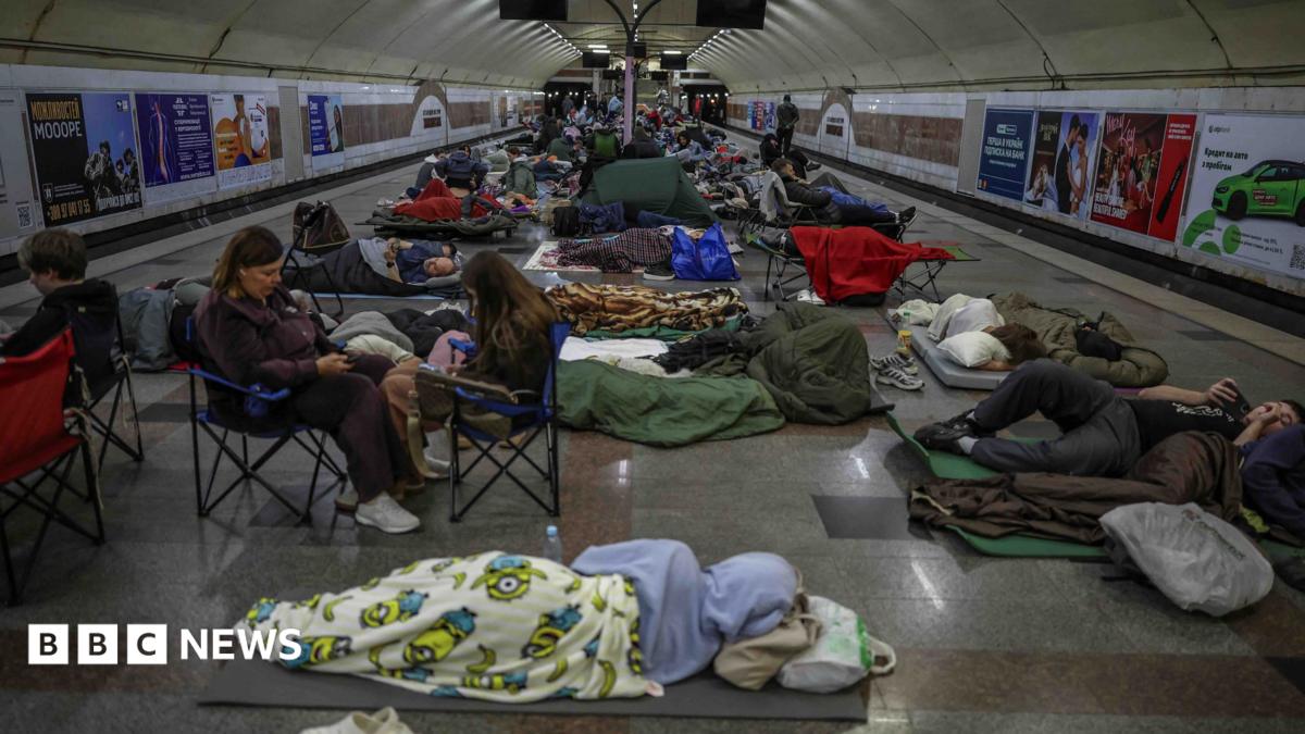 People sheltering and sleeping on floor of an underground metro station amid emergency conditions
