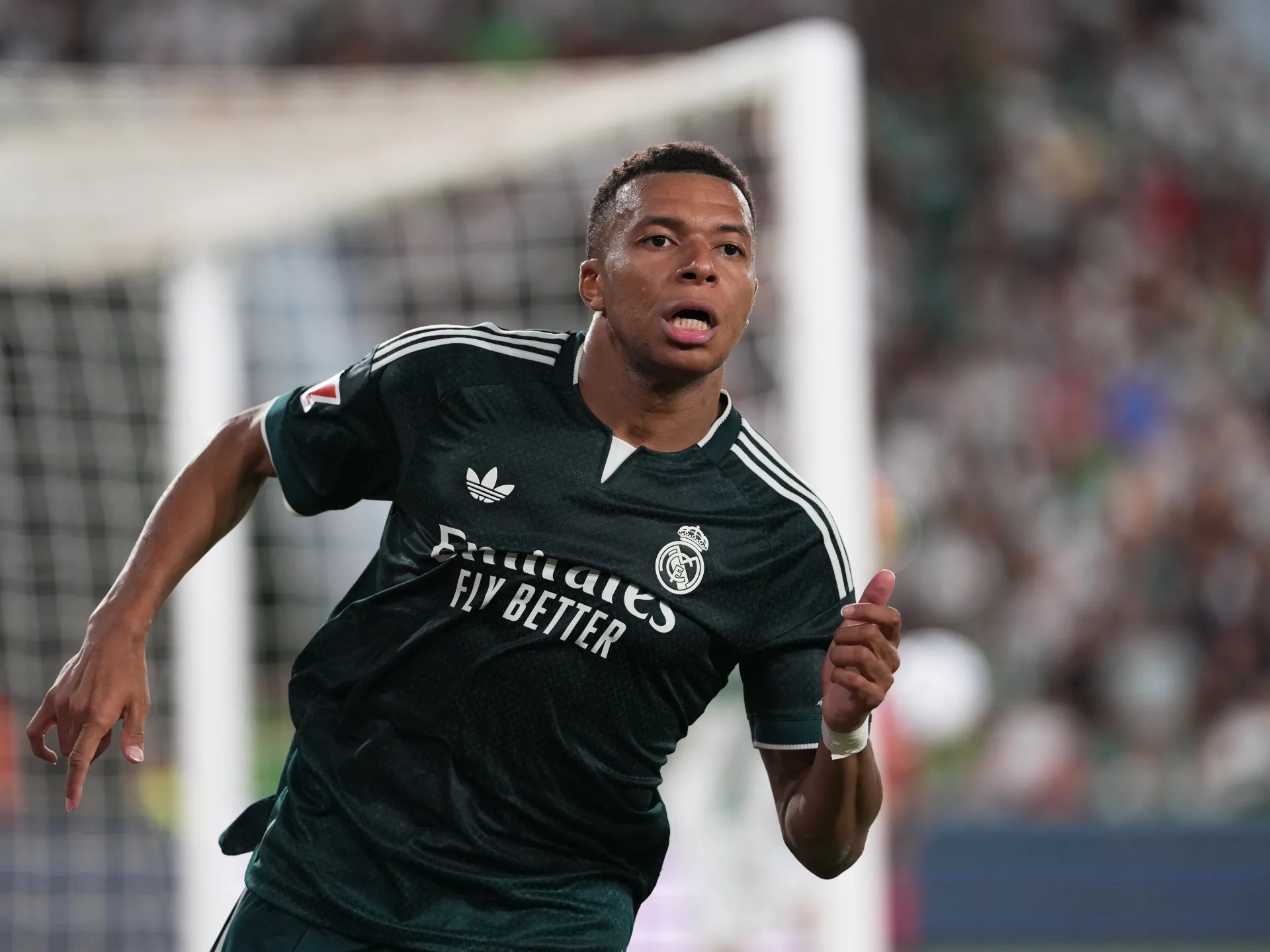Real Madrid player in black kit running during a football match