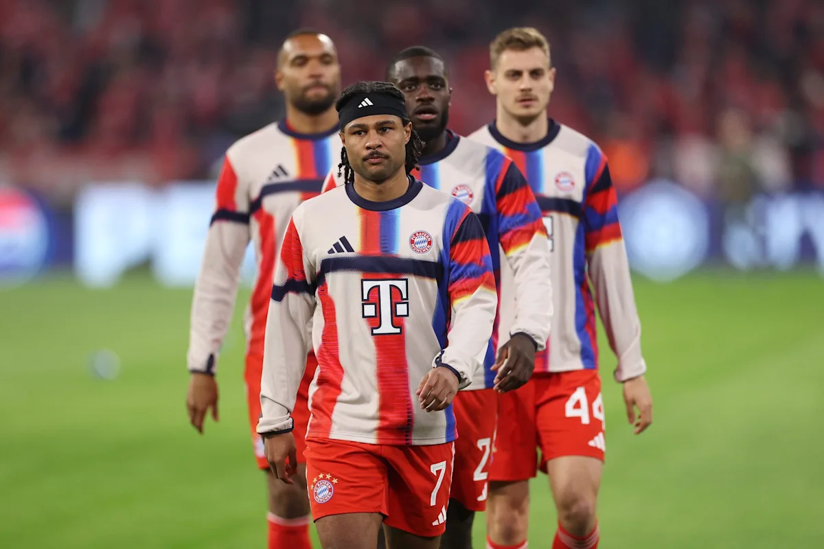 Bayern Munich players walk across the pitch wearing the club’s white, red and blue kits.