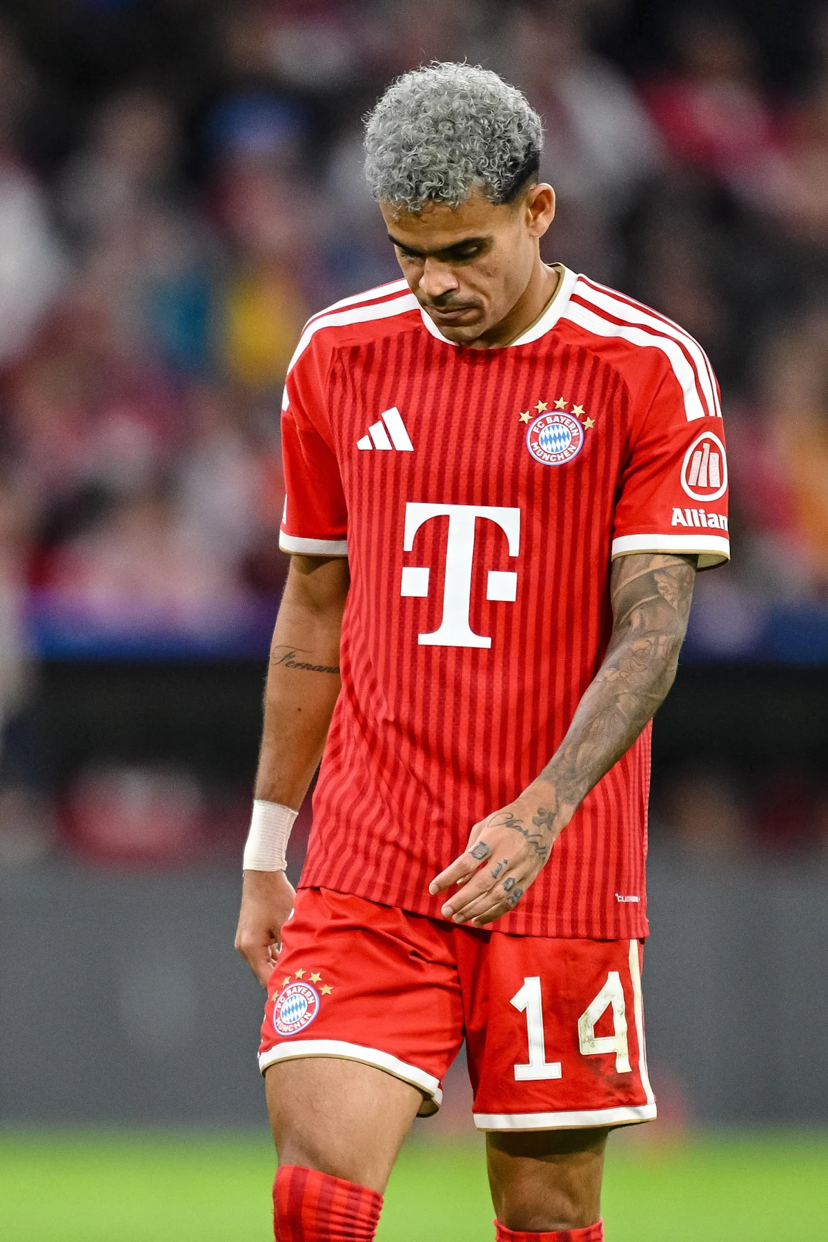 Bayern Munich player in red kit looks down during a football match