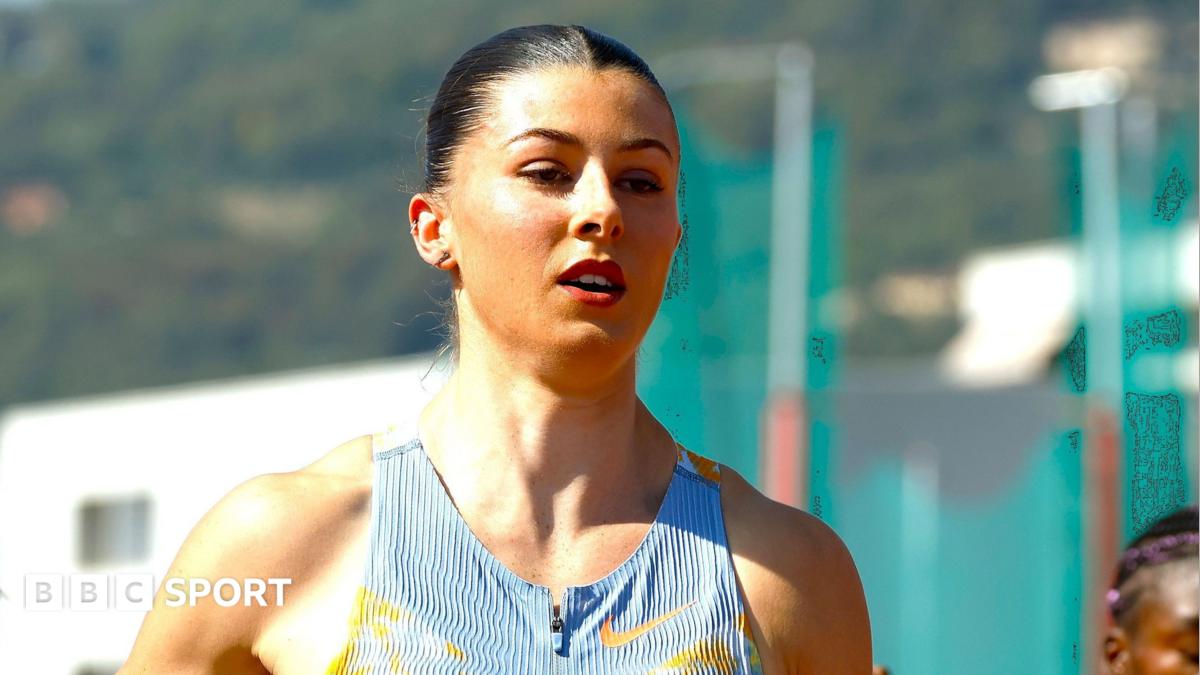 Female athlete in a blue Nike running top standing outdoors, with BBC Sport branding visible.