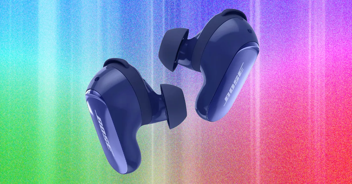 Pair of dark blue wireless earbuds floating against a colorful textured gradient background