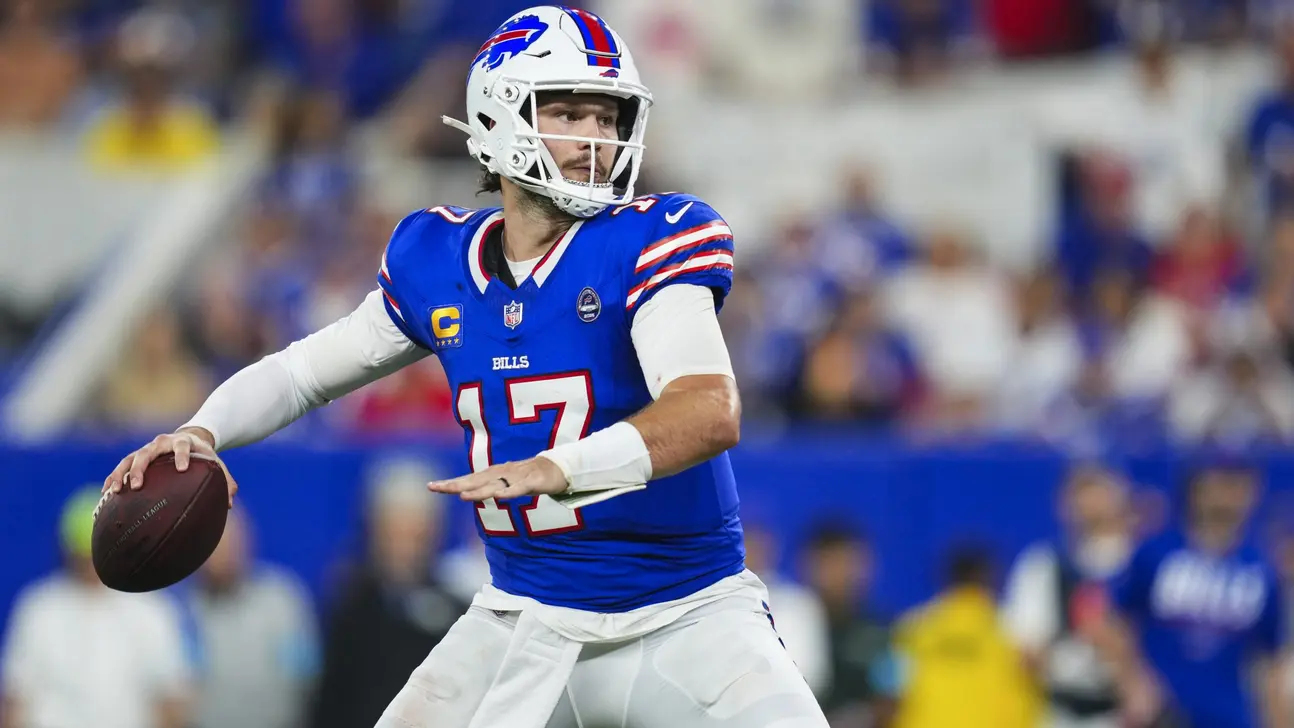 Buffalo Bills quarterback in a blue number 17 uniform holds a football during a game.