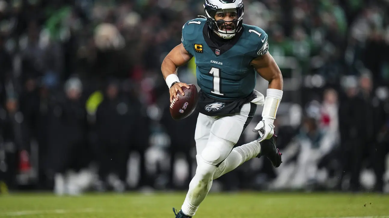 Football player in green jersey runs with the ball during a game