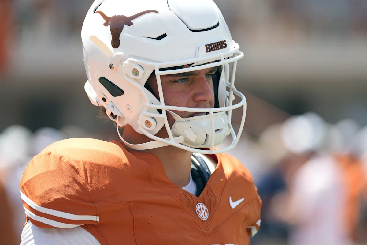 Football player wearing a white helmet and orange jersey during a game
