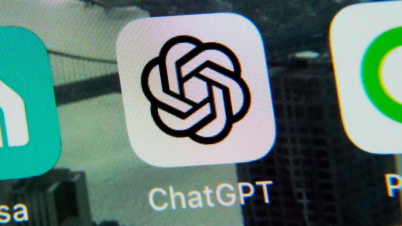 Close-up of a ChatGPT app icon and label on a screen, flanked by partial neighboring app icons.