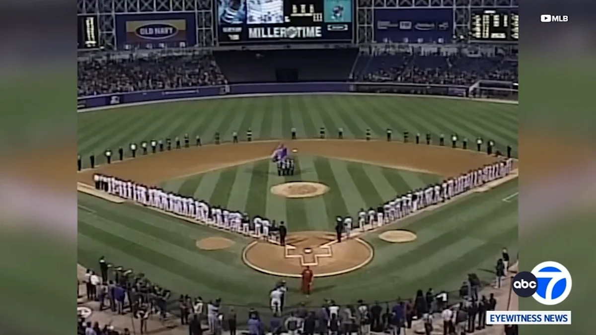 Baseball players line the field around the diamond during a pregame ceremony.