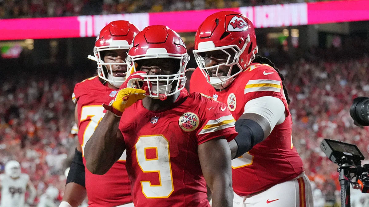 Kansas City Chiefs players in red uniforms celebrate on the field during a football game