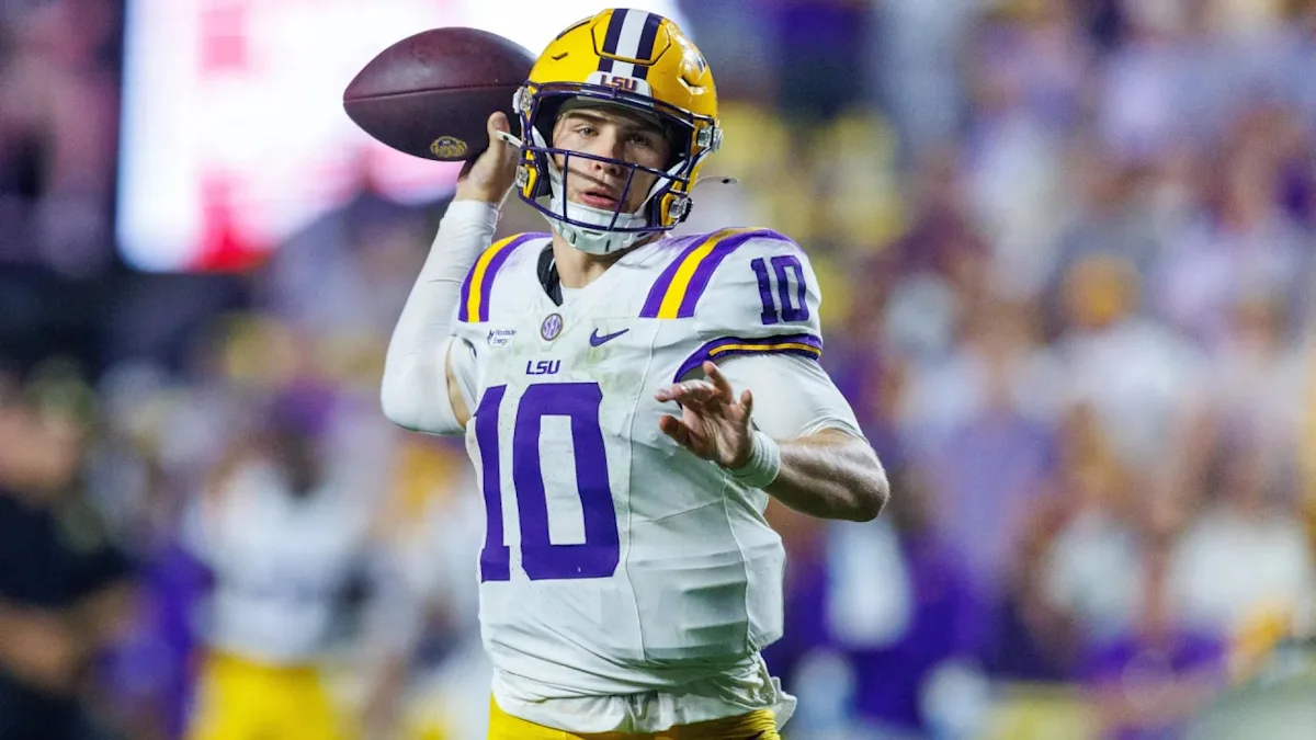 LSU quarterback in number 10 jersey prepares to throw a football during a game