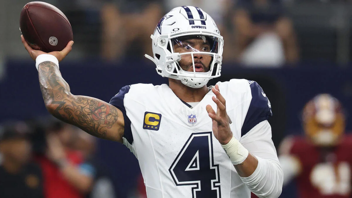 Dallas Cowboys quarterback in helmet and jersey prepares to throw a football