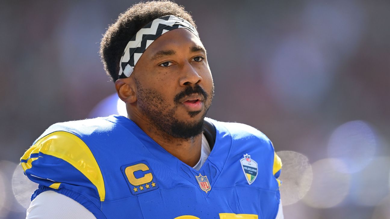 A football player in a blue and yellow uniform looks ahead during a game.