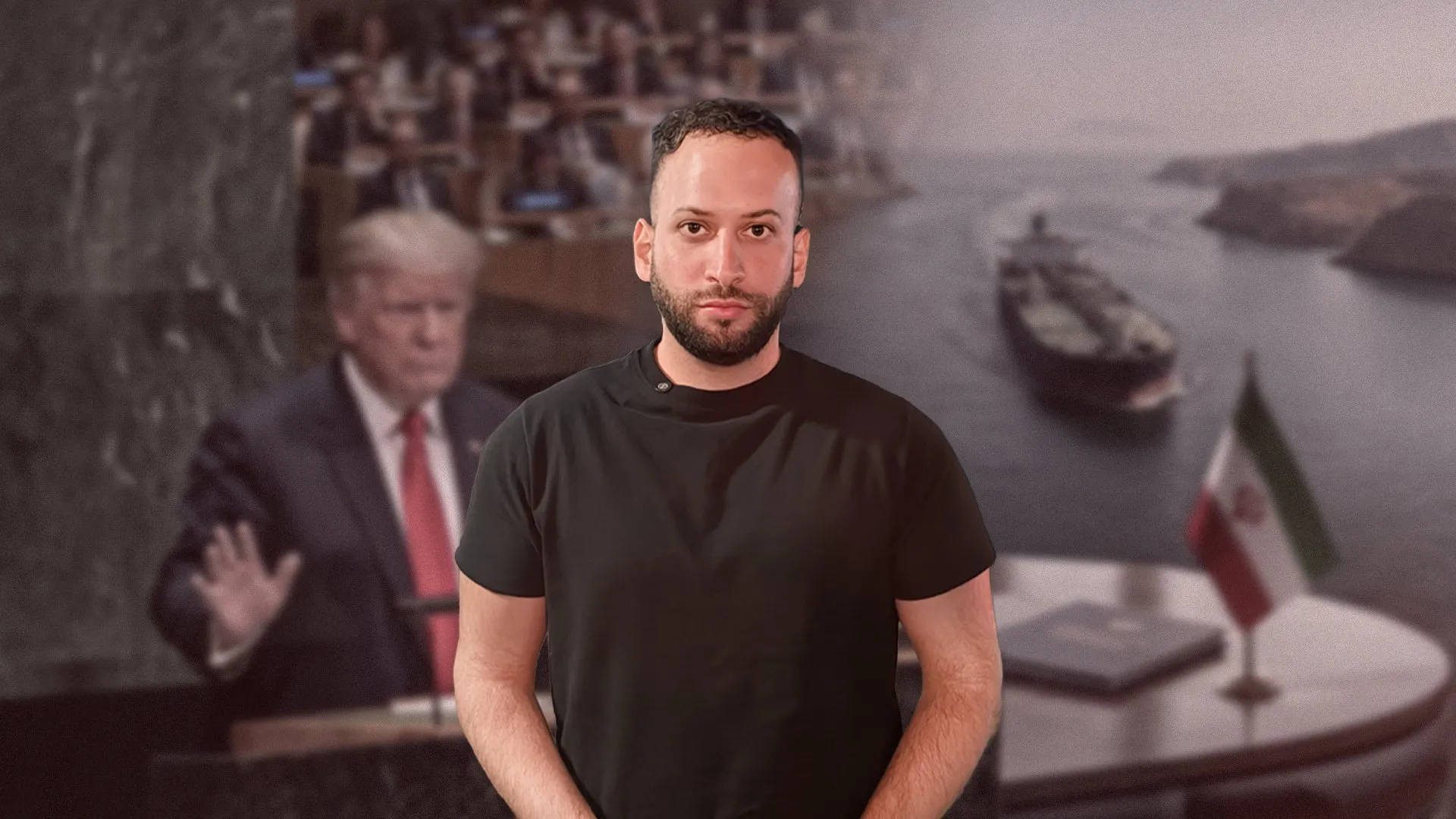 A man in a black shirt stands before a blurred image of officials and flags.