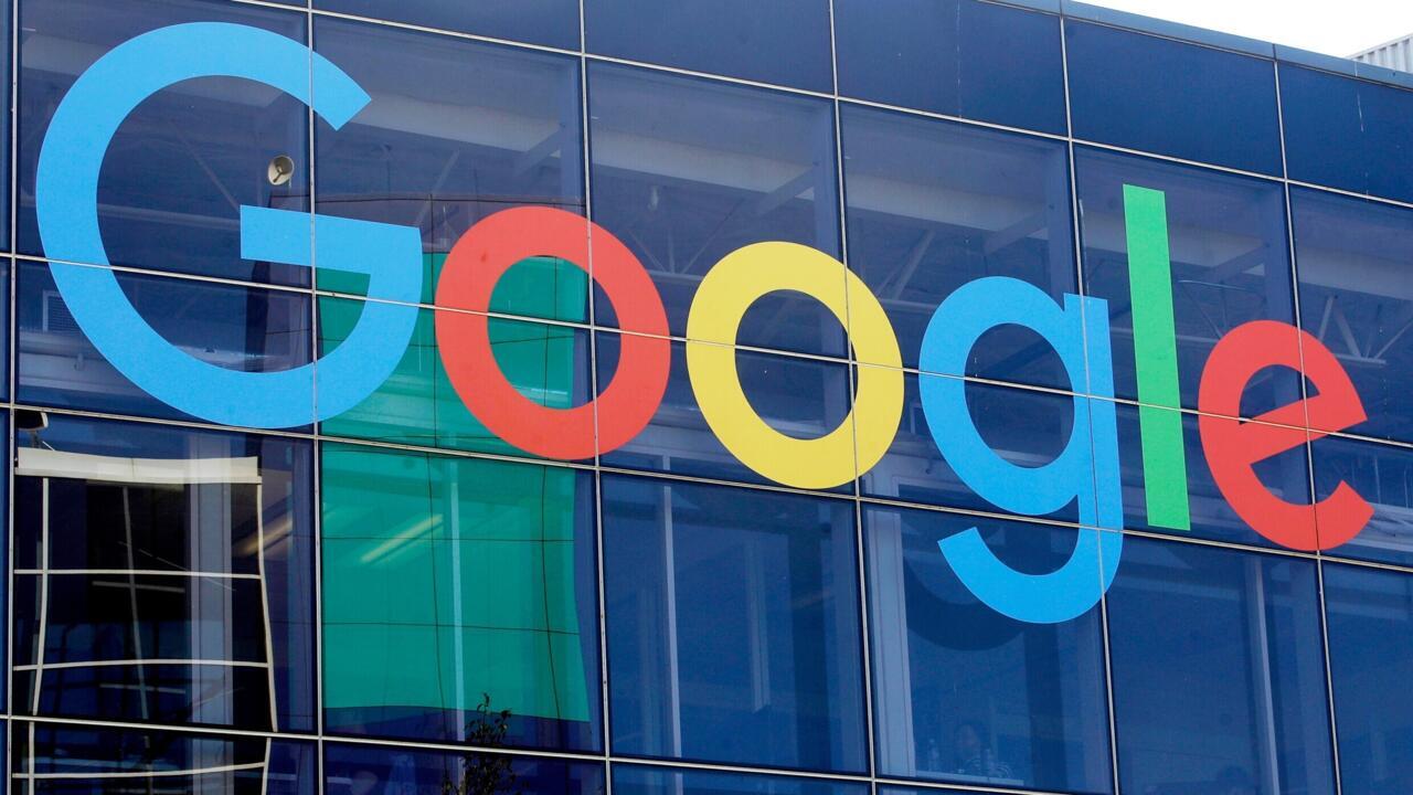 Colorful Google logo displayed across the glass facade of a modern building