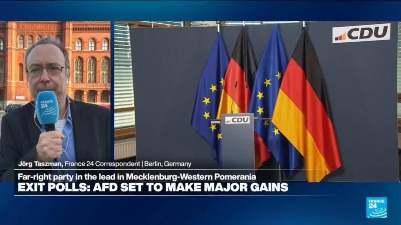 France 24 correspondent reports beside a CDU podium with German and European Union flags