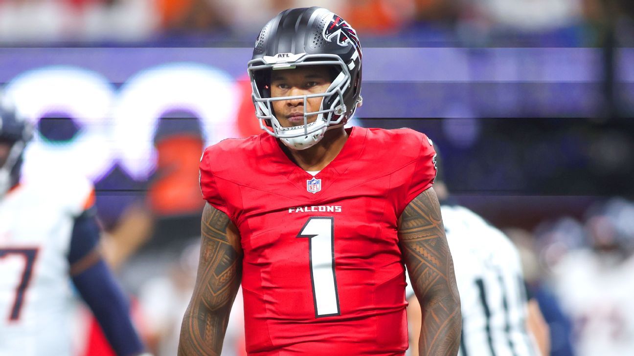 Atlanta Falcons football player in a red No. 1 jersey and helmet stands on the field.