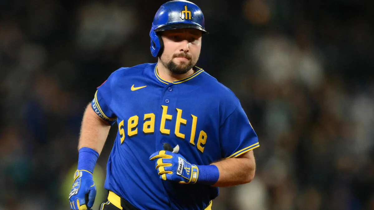 Baseball player in a Seattle Mariners uniform and helmet running during a game