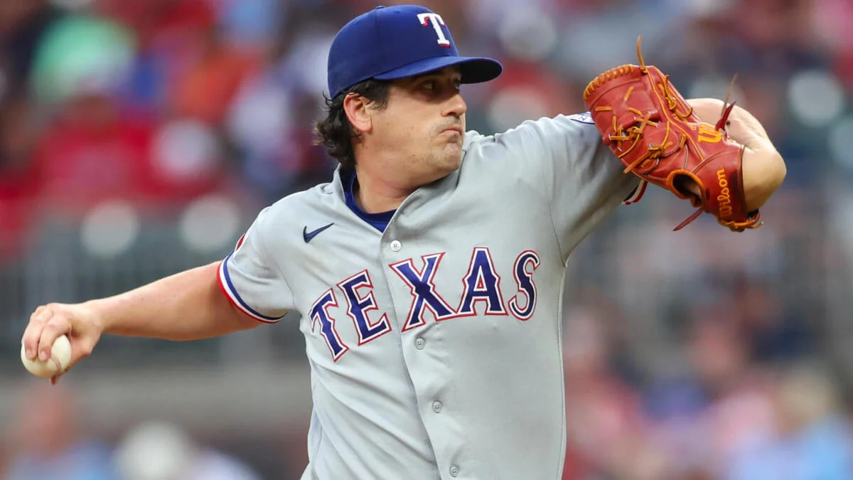 Baseball pitcher in Texas uniform throws a ball during a game.
