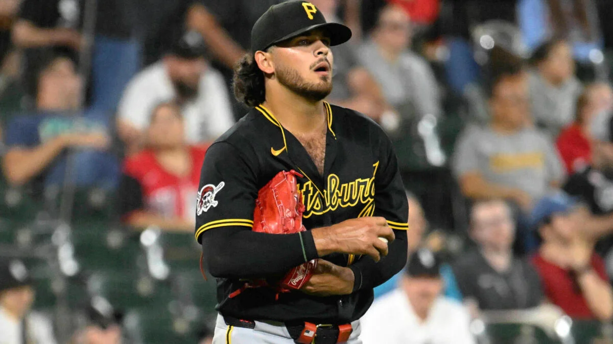 Pittsburgh pitcher in black uniform holds a red glove during a baseball game