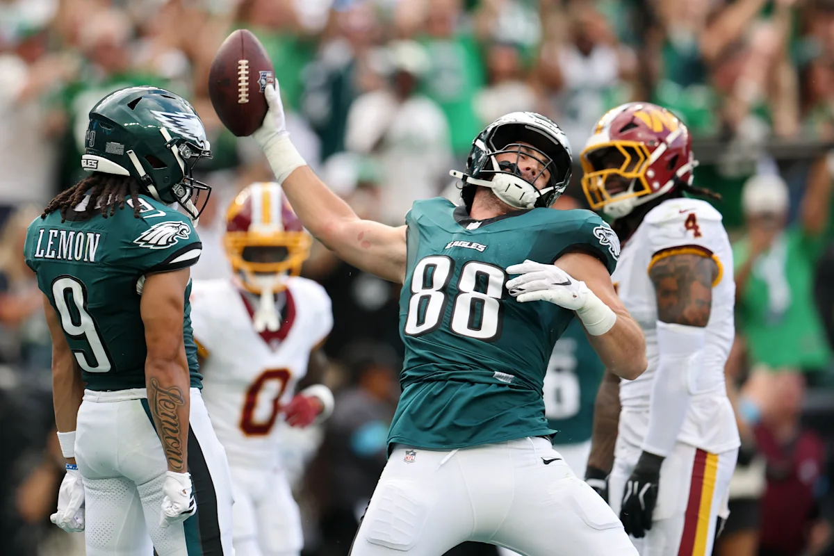 Eagles players celebrate as a tight end raises the football against Washington defenders