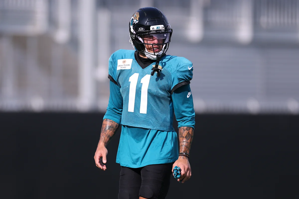 Jacksonville Jaguars player wearing number 11 stands on a football practice field.
