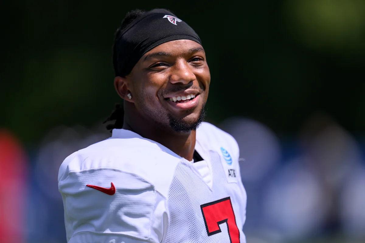 Smiling football player wearing a black headband and white jersey with number seven
