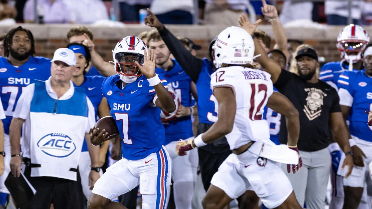 SMU football player runs with the ball as a Florida State defender pursues.