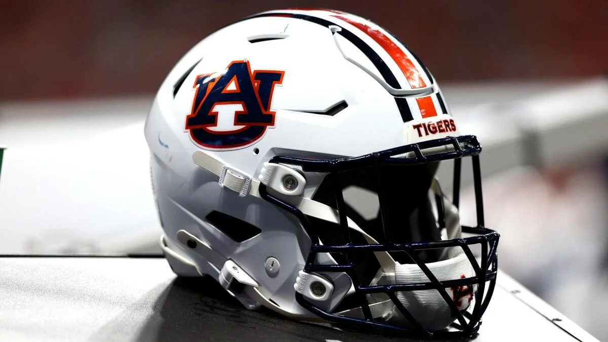 White Auburn Tigers football helmet with orange and navy details and a black face mask.