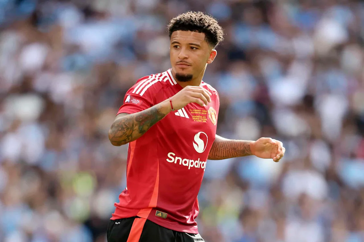 Footballer in a red Manchester United shirt runs during a match