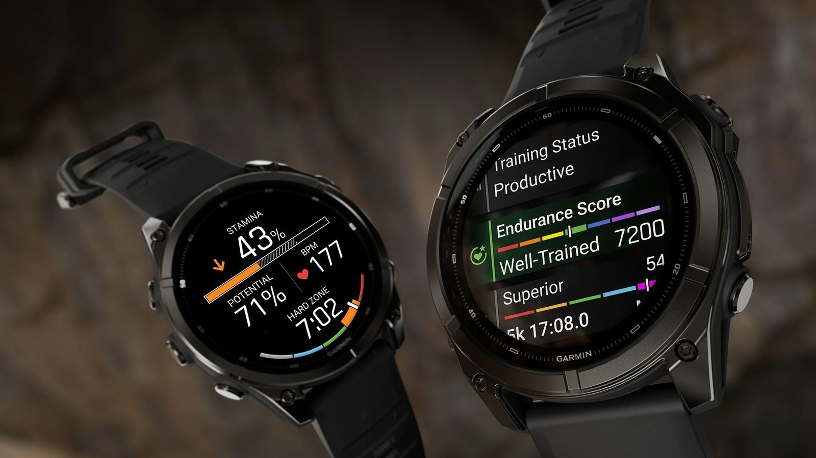Two black Garmin sports watches display colorful training metrics against a dark, blurred background.