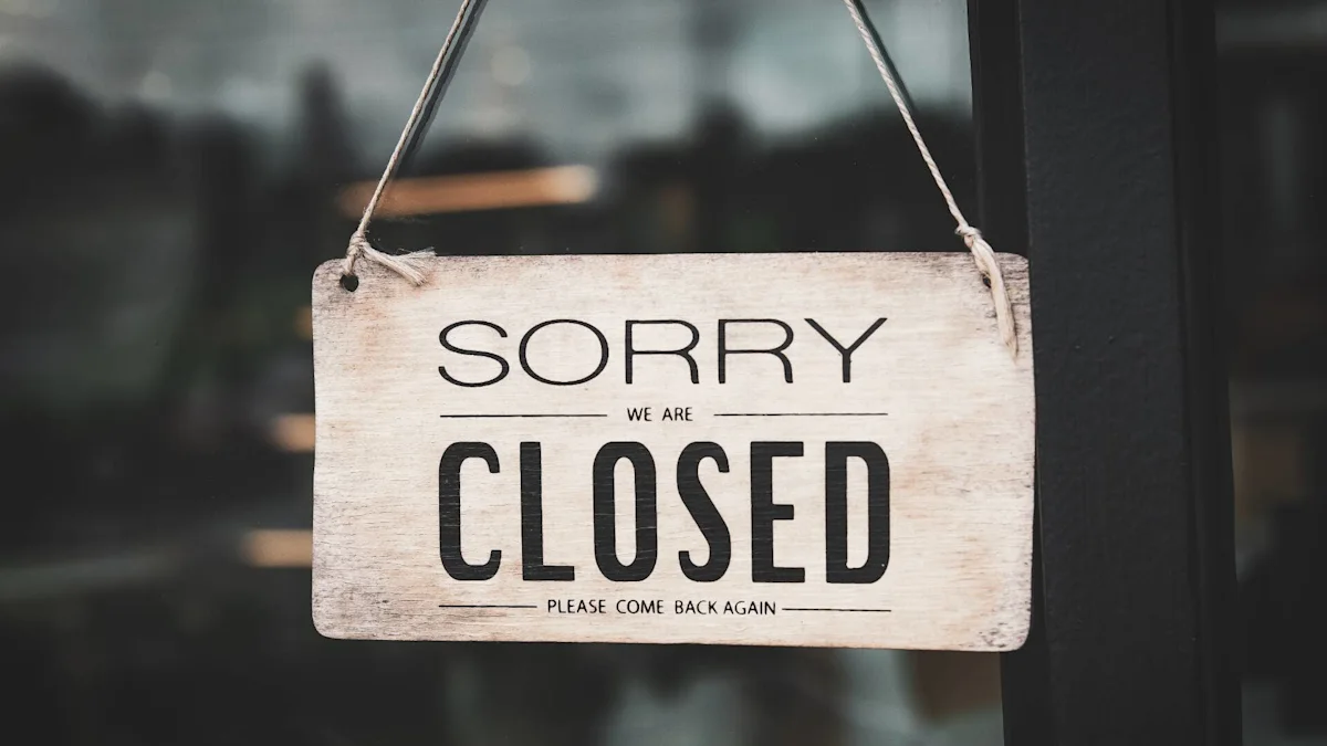 Weathered wooden sign reading “SORRY WE ARE CLOSED” hanging outside a storefront.