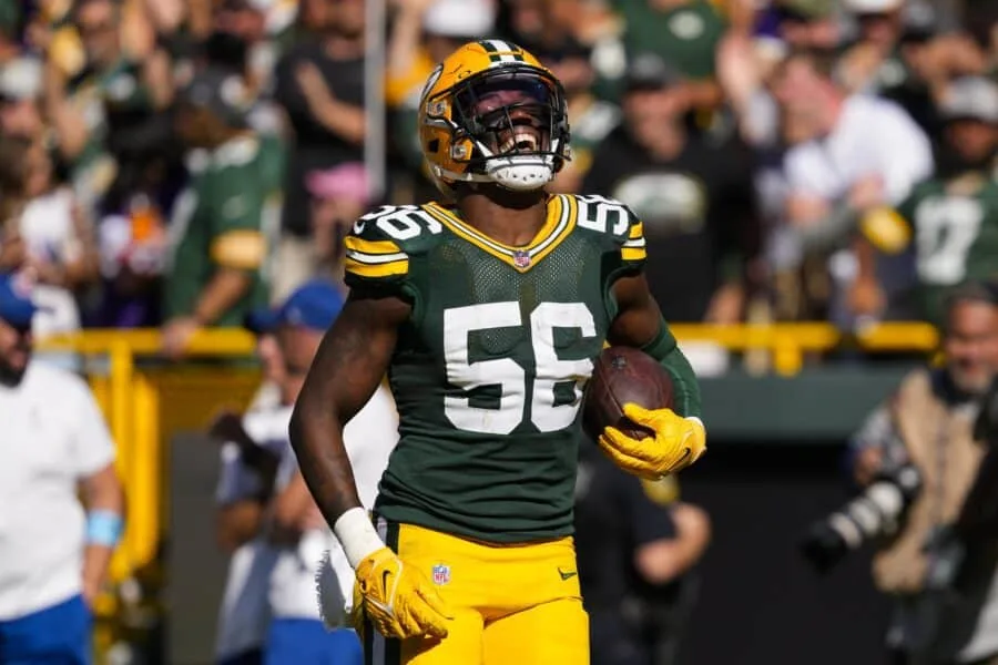 Green Bay Packers football player wearing number 55 runs with the ball during a game